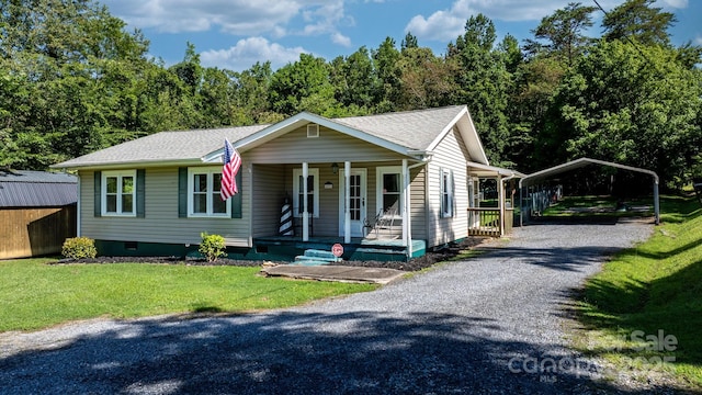 4006 Sol Mull St, Morganton, NC 28655 - view of front of property featuring a carport, covered porch, a front yard, gravel driveway, and roof with shingles