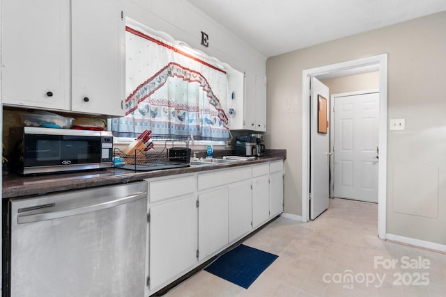 4006 Sol Mull St, Morganton, NC 28655 - kitchen with stainless steel appliances, white cabinets, and dark countertops