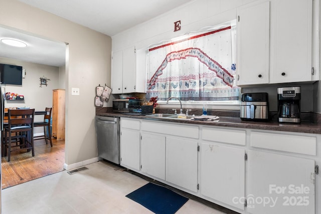 4006 Sol Mull St, Morganton, NC 28655 - kitchen with appliances with stainless steel finishes, dark countertops, white cabinets, and light flooring