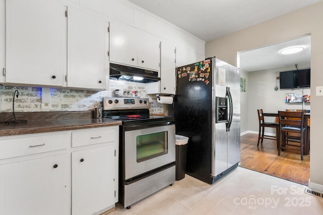 4006 Sol Mull St, Morganton, NC 28655 - kitchen with stainless steel appliances, under cabinet range hood, dark countertops, white cabinetry, and decorative backsplash