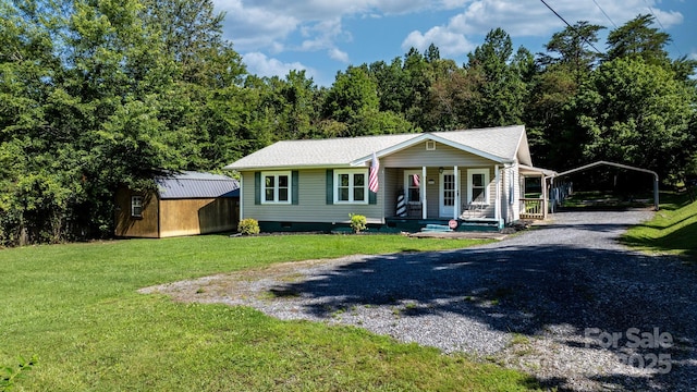 4006 Sol Mull St, Morganton, NC 28655 - view of front of home featuring a porch, a detached carport, gravel driveway, a front yard, and crawl space