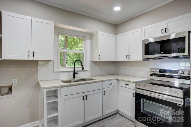 9763 Pine Tree Rd, Norwood, NC 28128 - kitchen featuring stainless steel appliances, white cabinets, backsplash, light stone countertops, and recessed lighting