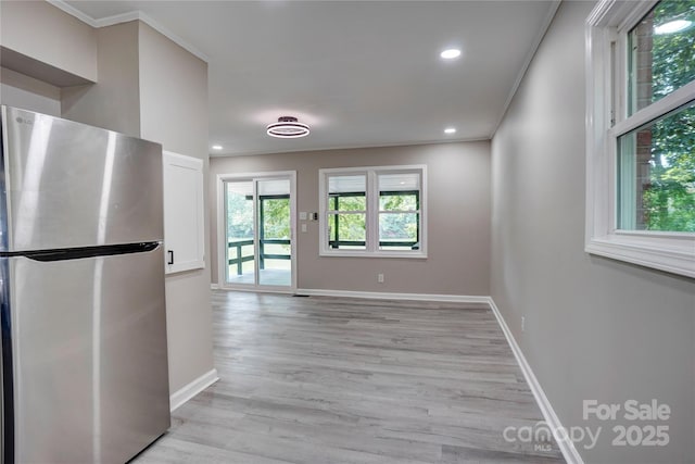 9763 Pine Tree Rd, Norwood, NC 28128 - kitchen featuring freestanding refrigerator, light wood-type flooring, recessed lighting, crown molding, and white cabinets