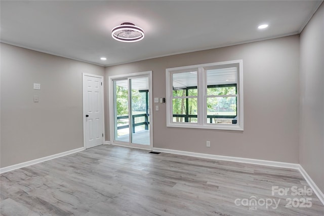9763 Pine Tree Rd, Norwood, NC 28128 - unfurnished room with light wood-type flooring, recessed lighting, and crown molding