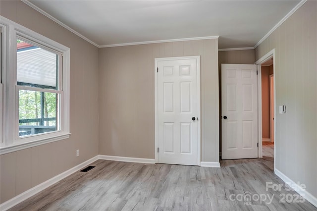 9763 Pine Tree Rd, Norwood, NC 28128 - unfurnished bedroom with light wood-type flooring and crown molding