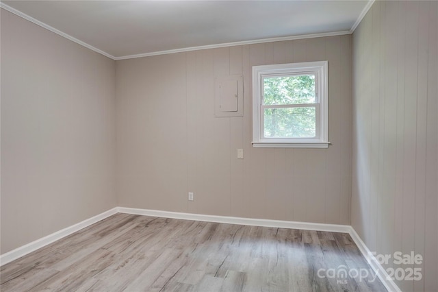 9763 Pine Tree Rd, Norwood, NC 28128 - spare room with light wood-type flooring, electric panel, and ornamental molding