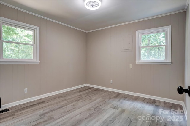9763 Pine Tree Rd, Norwood, NC 28128 - spare room featuring wood finished floors, healthy amount of natural light, crown molding, and electric panel