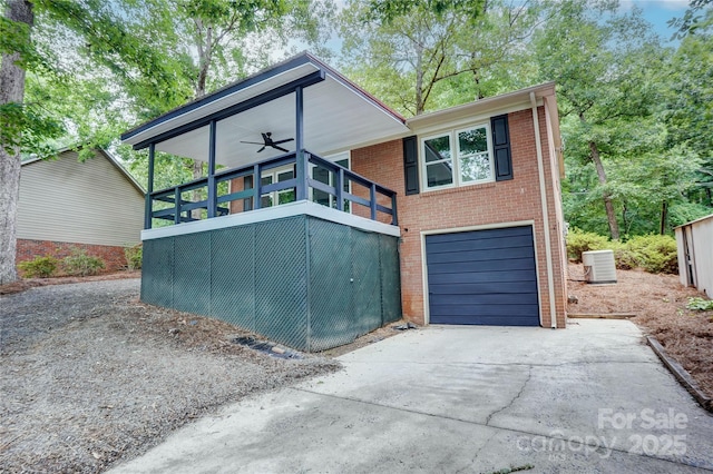 9763 Pine Tree Rd, Norwood, NC 28128 - view of front of house with driveway, brick siding, an attached garage, and a ceiling fan