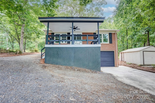 9763 Pine Tree Rd, Norwood, NC 28128 - modern home featuring brick siding, concrete driveway, a ceiling fan, and an outbuilding