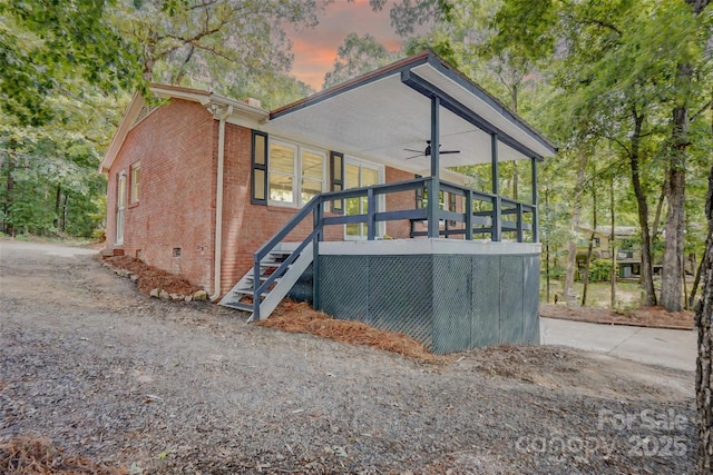 9763 Pine Tree Rd, Norwood, NC 28128 - rear view of house with ceiling fan, brick siding, and stairway