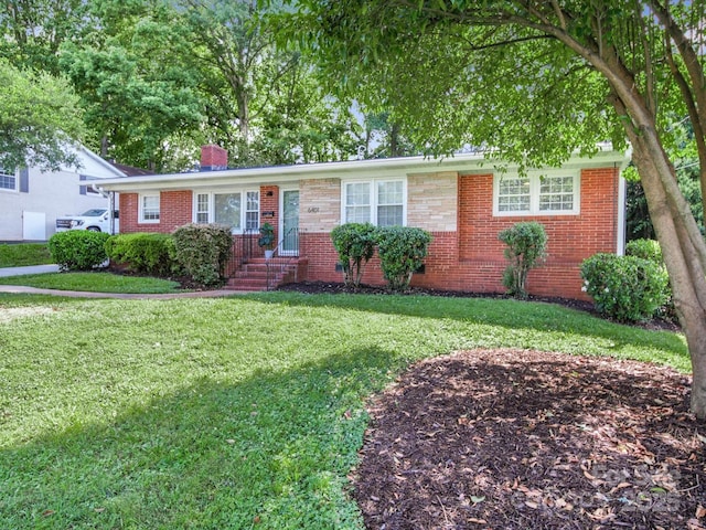 6401 Montpelier Rd, Charlotte, NC 28210 - view of front of property featuring a chimney, a front yard, and brick siding