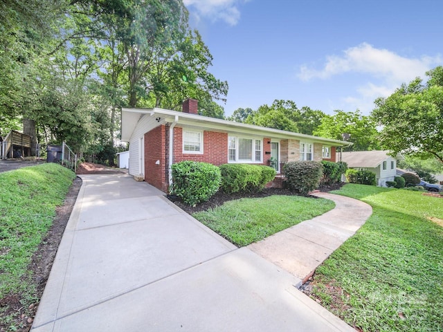 6401 Montpelier Rd, Charlotte, NC 28210 - ranch-style home with brick siding, a chimney, a front yard, and driveway