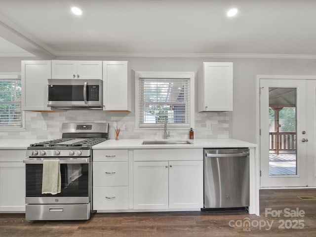 6401 Montpelier Rd, Charlotte, NC 28210 - kitchen featuring stainless steel appliances, ornamental molding, plenty of natural light, white cabinetry, and light countertops
