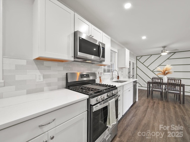 6401 Montpelier Rd, Charlotte, NC 28210 - kitchen with appliances with stainless steel finishes, tasteful backsplash, a ceiling fan, white cabinetry, and recessed lighting