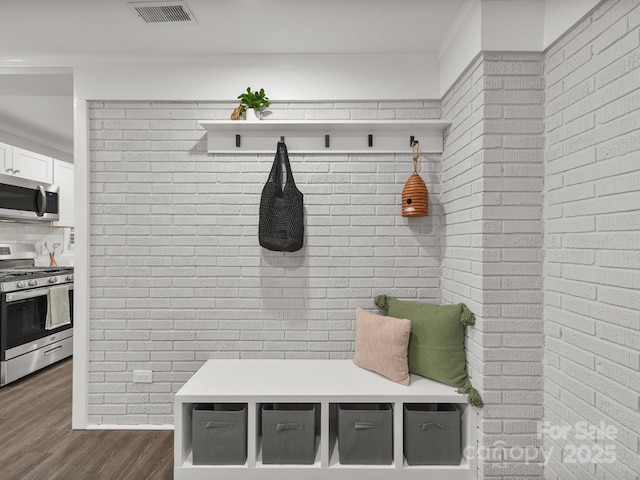 6401 Montpelier Rd, Charlotte, NC 28210 - mudroom featuring brick wall, dark wood-style floors, and crown molding