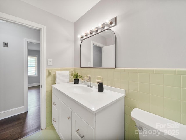 6401 Montpelier Rd, Charlotte, NC 28210 - half bath with vanity, tile walls, wainscoting, and wood finished floors