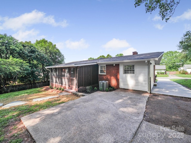 6401 Montpelier Rd, Charlotte, NC 28210 - rear view of house with a chimney, a sunroom, and brick siding