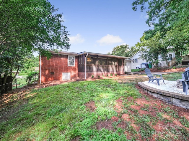 6401 Montpelier Rd, Charlotte, NC 28210 - back of property with a sunroom, brick siding, crawl space, and a fire pit