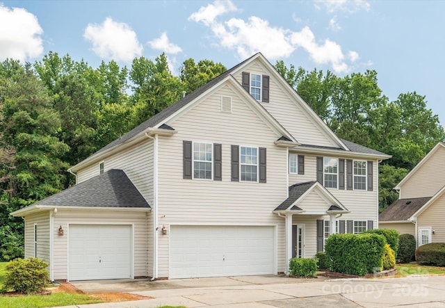 3043 Streamlet Way, Monroe, NC 28110 - traditional-style house with concrete driveway, a garage, a shingled roof, and view of scattered trees
