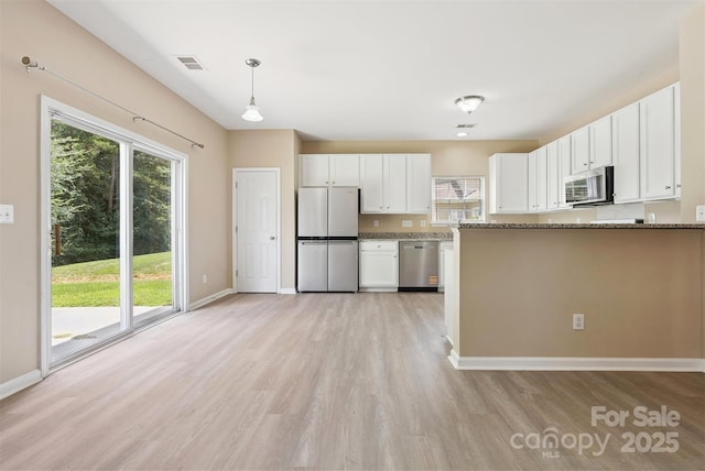 3043 Streamlet Way, Monroe, NC 28110 - kitchen featuring stainless steel appliances, light wood finished floors, white cabinetry, and stone counters
