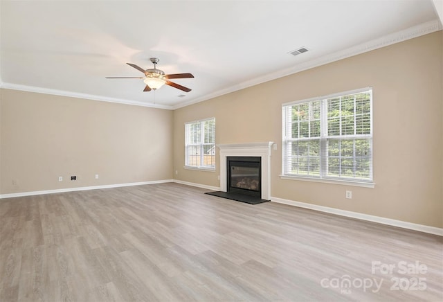 3043 Streamlet Way, Monroe, NC 28110 - unfurnished living room featuring light wood-type flooring, a glass covered fireplace, a ceiling fan, and ornamental molding