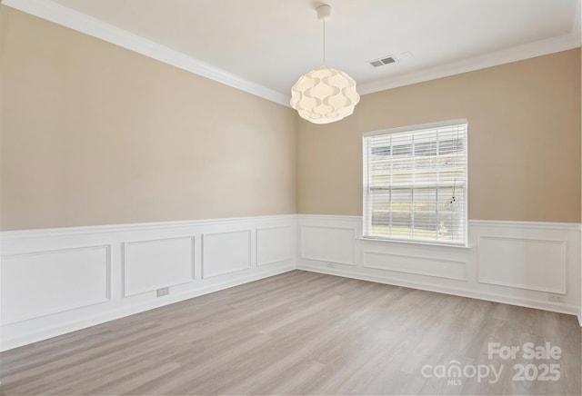 3043 Streamlet Way, Monroe, NC 28110 - unfurnished room with light wood-style flooring, wainscoting, and ornamental molding