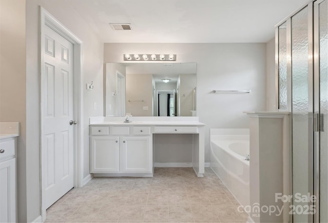 3043 Streamlet Way, Monroe, NC 28110 - full bathroom featuring vanity, a bath, a shower stall, and tile patterned floors