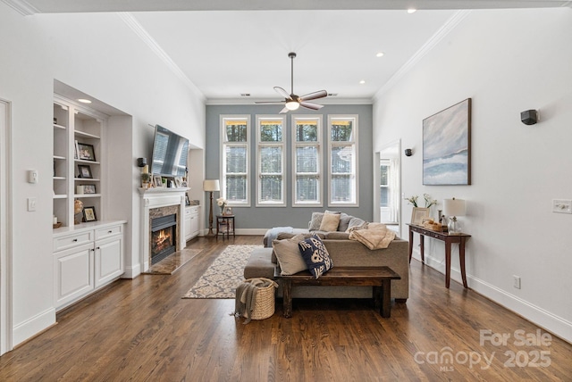 347 Bayberry Creek Cir, Mooresville, NC 28117 - living area featuring crown molding, a ceiling fan, a warm lit fireplace, dark wood-style flooring, and recessed lighting
