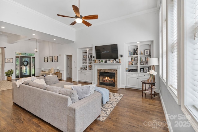 347 Bayberry Creek Cir, Mooresville, NC 28117 - living area with a fireplace with flush hearth, a ceiling fan, ornamental molding, dark wood-type flooring, and built in features