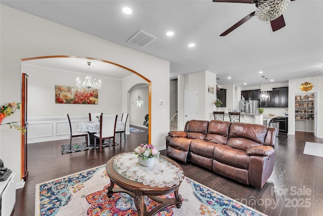 1012 Leland Dr, Wesley Chapel, NC 28104 - living area with arched walkways, a chandelier, ceiling fan, dark wood-style flooring, and recessed lighting