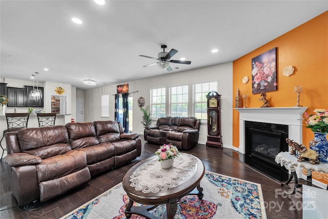 1012 Leland Dr, Wesley Chapel, NC 28104 - living room featuring ceiling fan, recessed lighting, a glass covered fireplace, and dark wood-style flooring