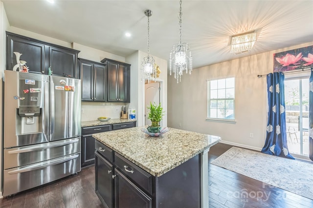 1012 Leland Dr, Wesley Chapel, NC 28104 - kitchen featuring stainless steel fridge with ice dispenser, a kitchen island, dark wood finished floors, light stone countertops, and recessed lighting