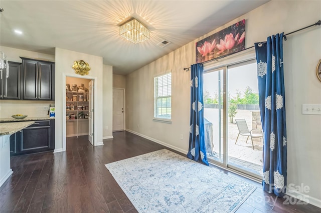 1012 Leland Dr, Wesley Chapel, NC 28104 - foyer with a chandelier and dark wood finished floors