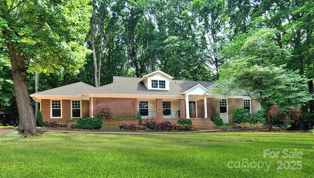 25 Fairway Rdg, Lake Wylie, SC 29710 - view of front of home with a front yard, brick siding, roof with shingles, and a porch