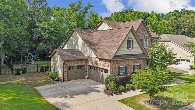 11412 Preservation Ln, Charlotte, NC 28278 - view of front of home featuring a standing seam roof, concrete driveway, stone siding, roof with shingles, and a garage