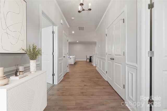 416 Balboa St, Matthews, NC 28104 - hallway with light wood-type flooring, crown molding, recessed lighting, and a chandelier