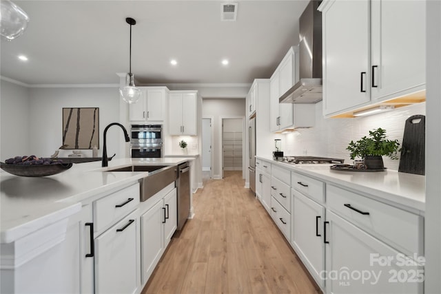 416 Balboa St, Matthews, NC 28104 - kitchen with wall chimney exhaust hood, appliances with stainless steel finishes, tasteful backsplash, ornamental molding, and white cabinets