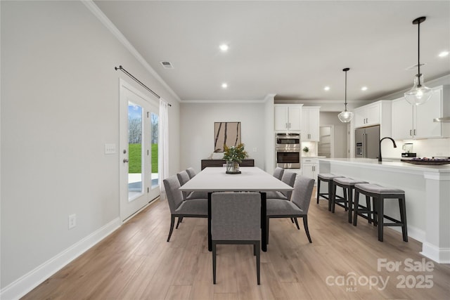 416 Balboa St, Matthews, NC 28104 - dining space with ornamental molding, light wood finished floors, and recessed lighting