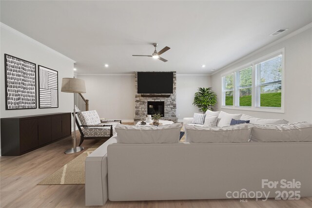 416 Balboa St, Matthews, NC 28104 - living area with crown molding, light wood-style floors, a ceiling fan, a fireplace, and recessed lighting