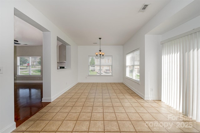 124 Glade Valley Ave, Mooresville, NC 28117 - unfurnished room with a chandelier, healthy amount of natural light, and light tile patterned floors