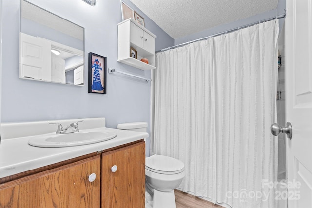 9606 Vinca Cir Unit E, Charlotte, NC 28213 - full bath with vanity, a textured ceiling, a shower with curtain, and wood finished floors