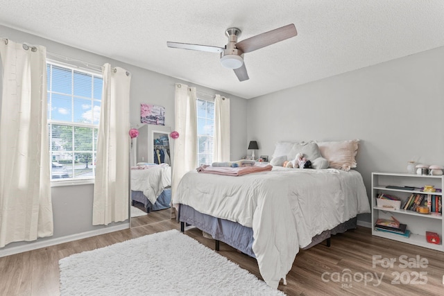 9606 Vinca Cir Unit E, Charlotte, NC 28213 - bedroom featuring wood finished floors, a textured ceiling, and a ceiling fan