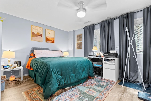 9606 Vinca Cir Unit E, Charlotte, NC 28213 - bedroom with wood finished floors and ceiling fan