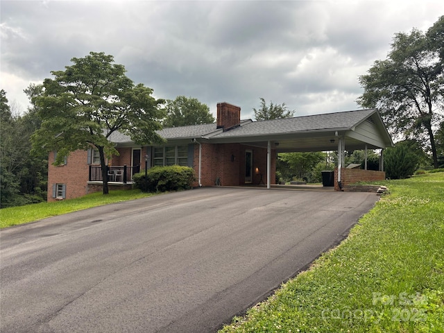 356 Lucky Hollow Rd, Hickory, NC 28601 - ranch-style home featuring a chimney, driveway, brick siding, a carport, and a front yard