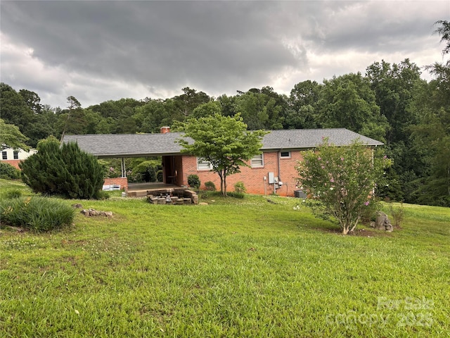 356 Lucky Hollow Rd, Hickory, NC 28601 - rear view of house with a yard, a wooded view, brick siding, and a chimney