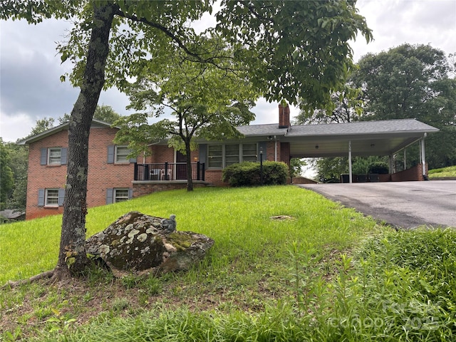356 Lucky Hollow Rd, Hickory, NC 28601 - view of front of house with brick siding, a front yard, a chimney, and a carport