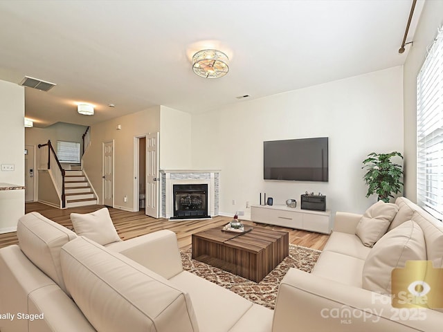 12131 Honor Guard Ave, Charlotte, NC 28277 - living room featuring wood finished floors, stairs, and a premium fireplace