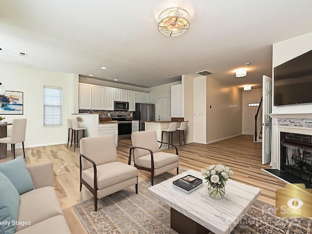 12131 Honor Guard Ave, Charlotte, NC 28277 - living room featuring light wood-style flooring and recessed lighting
