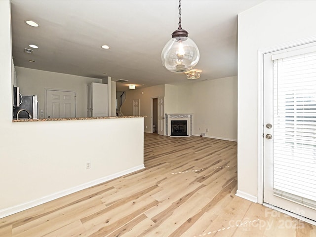 12131 Honor Guard Ave, Charlotte, NC 28277 - unfurnished living room featuring light wood-style floors, recessed lighting, and a fireplace