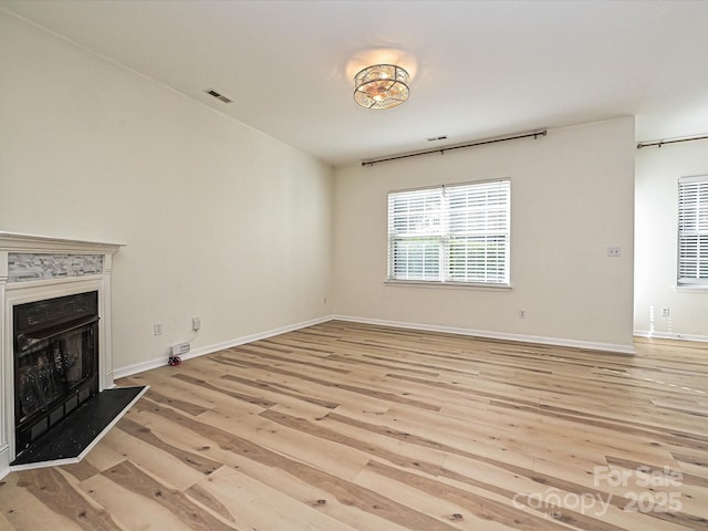 12131 Honor Guard Ave, Charlotte, NC 28277 - unfurnished living room featuring light wood-style flooring and a fireplace
